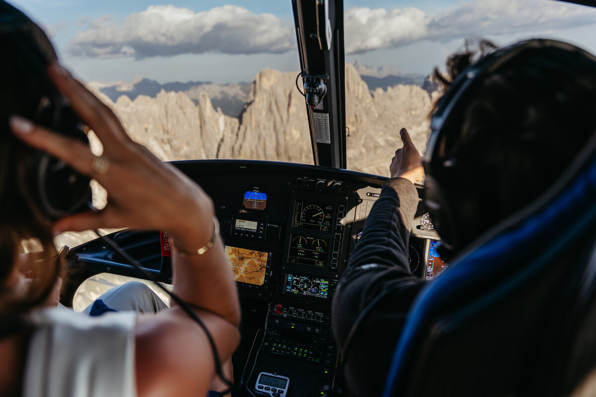 Helicopter flying over Dolomites peaks