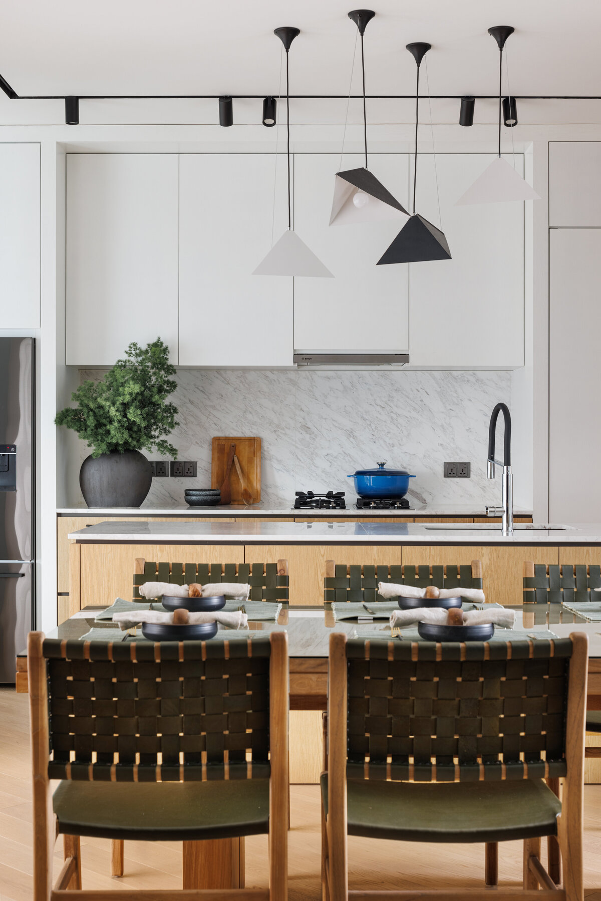 Apartment style kitchen with green chairs