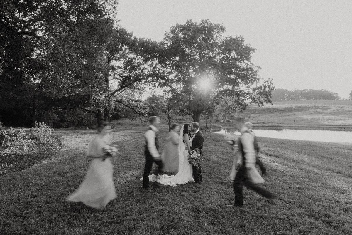 Bride and groom in focus with bridal party blurred