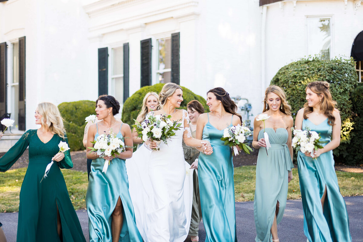 Bride with bridesmaids in sea green dresses at The Carrick House Wedding venue in Lexington, KY