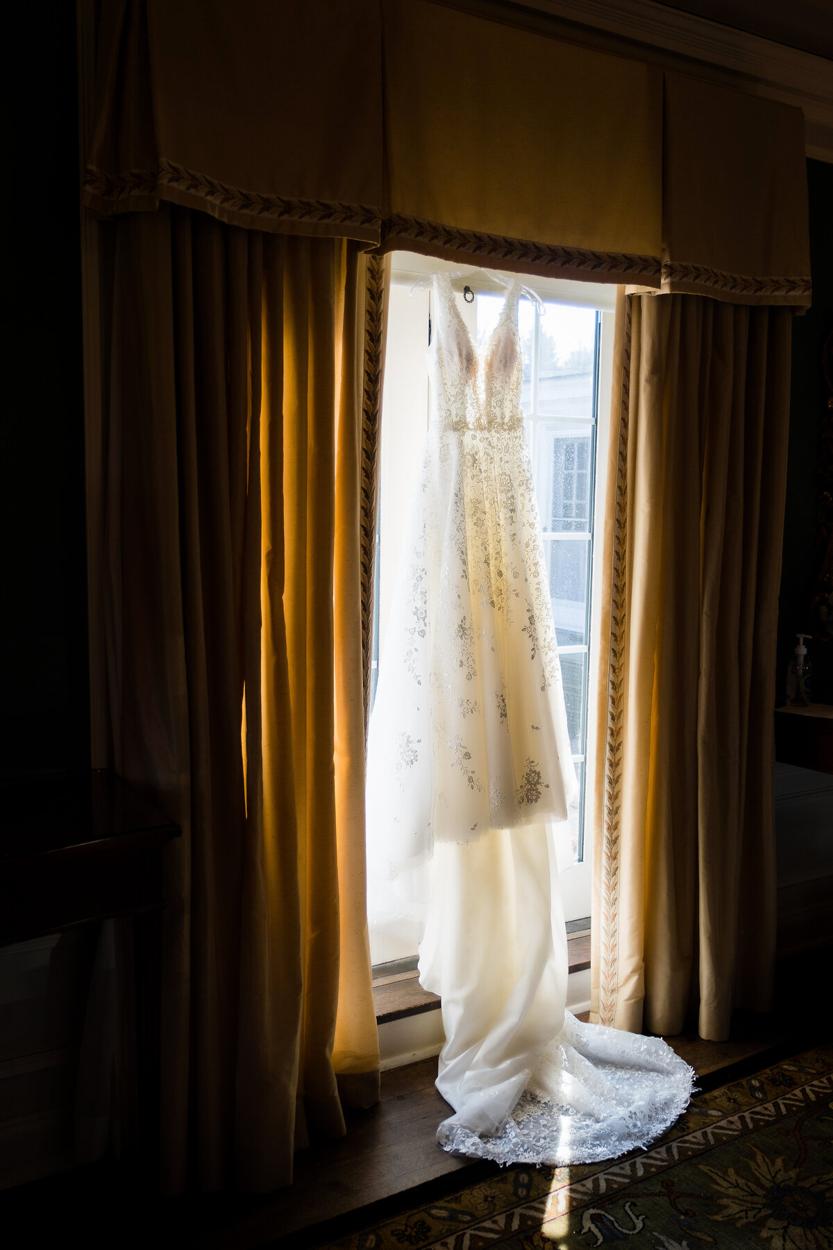 wedding dress hanging in window