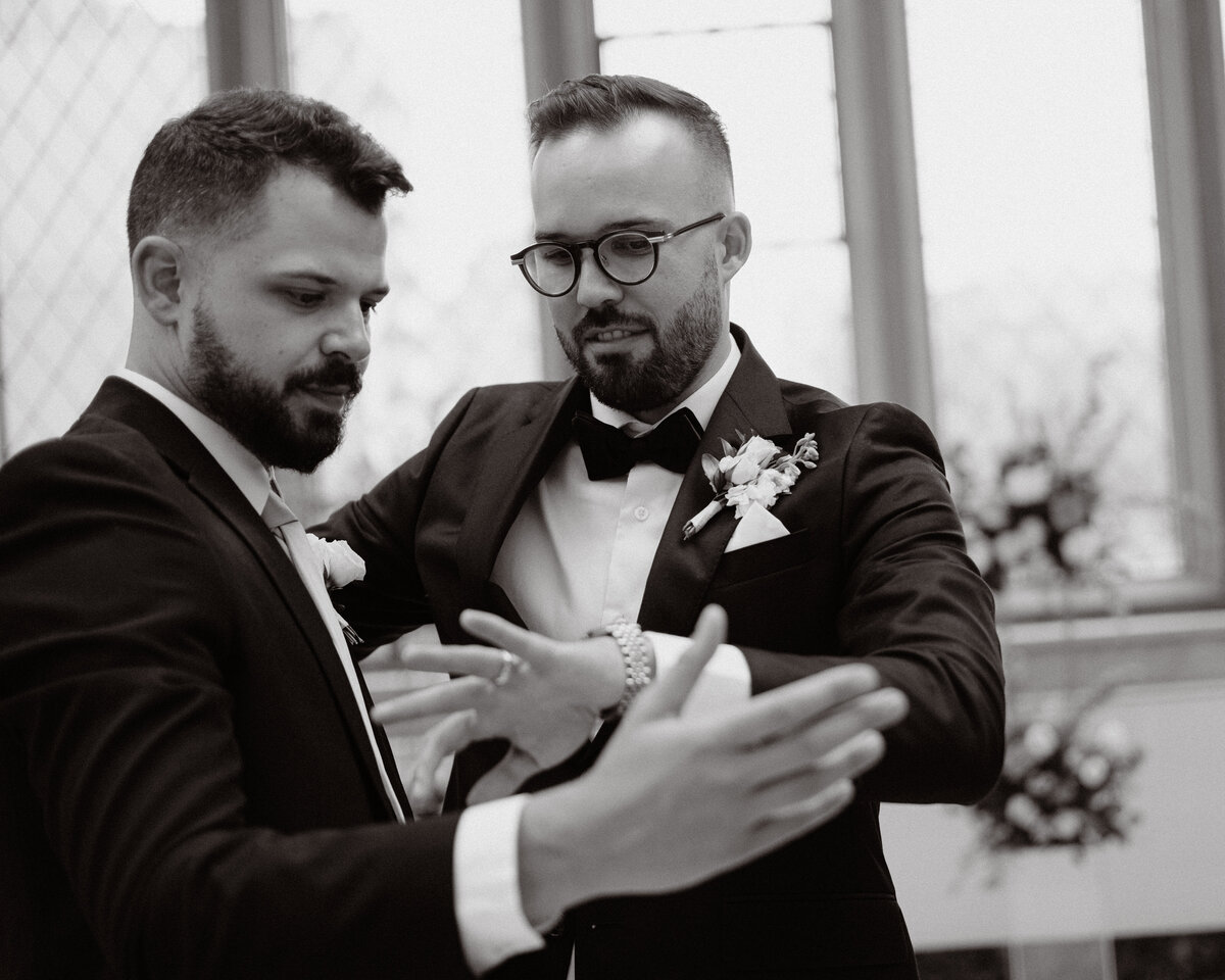 groom showing groomsman his ring