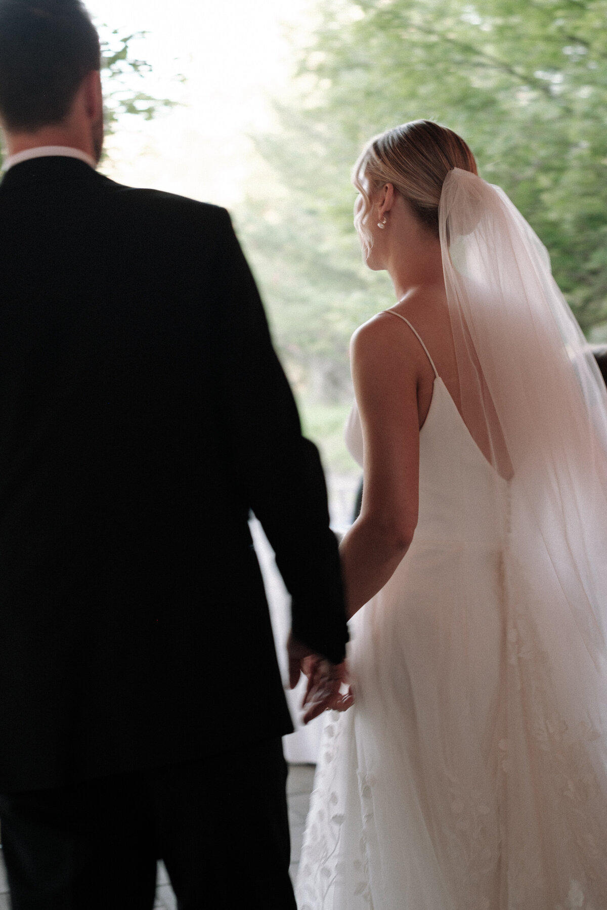 Bride and groom walking through their  wedding in a dreamy motion