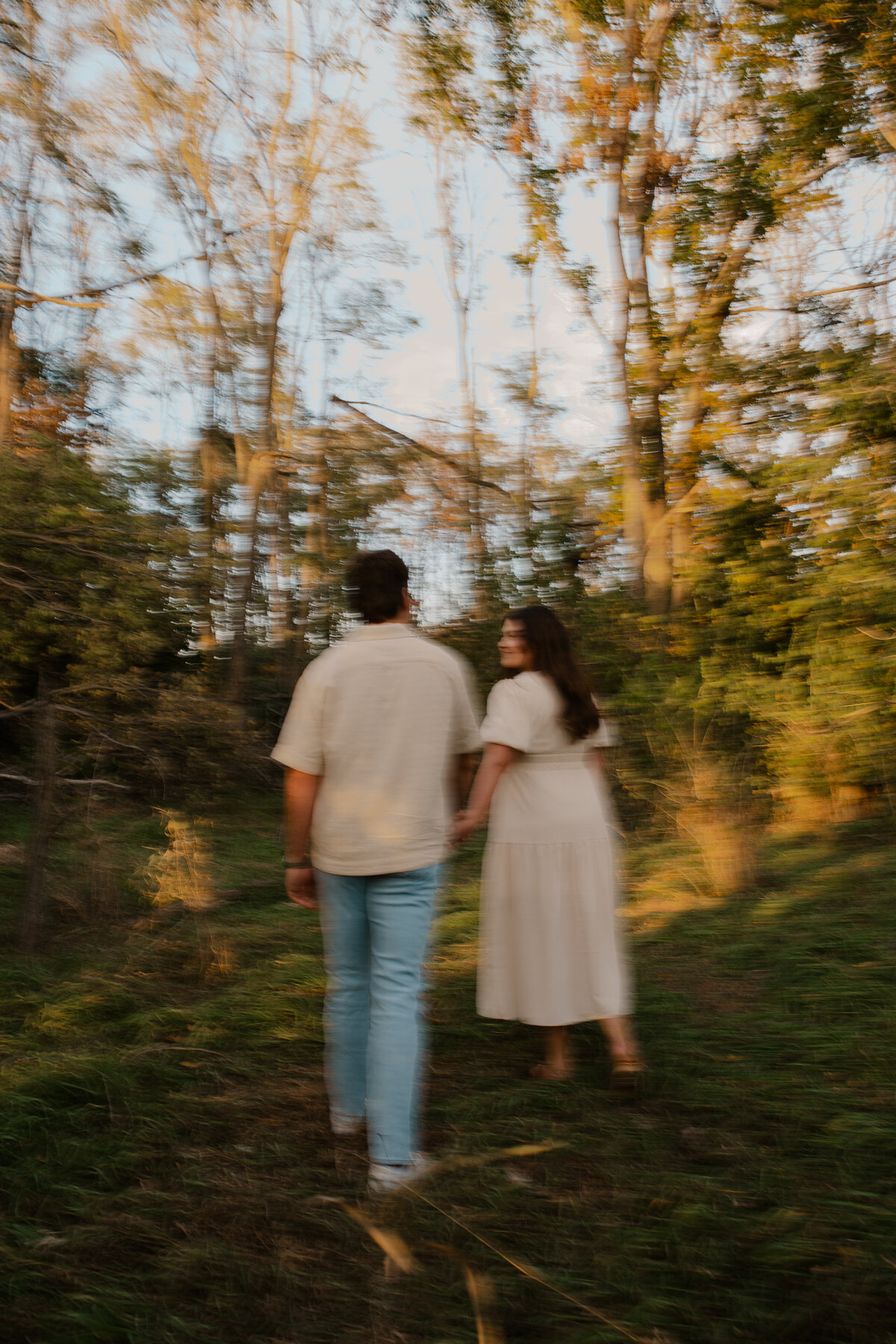 Couple's engagement session in Omaha during golden hour, surrounded by warm fall foliage – captured by Tori Nichole Photography. Authentic, romantic moments in a stunning autumnal setting, reflecting the beauty of the season and their love story.