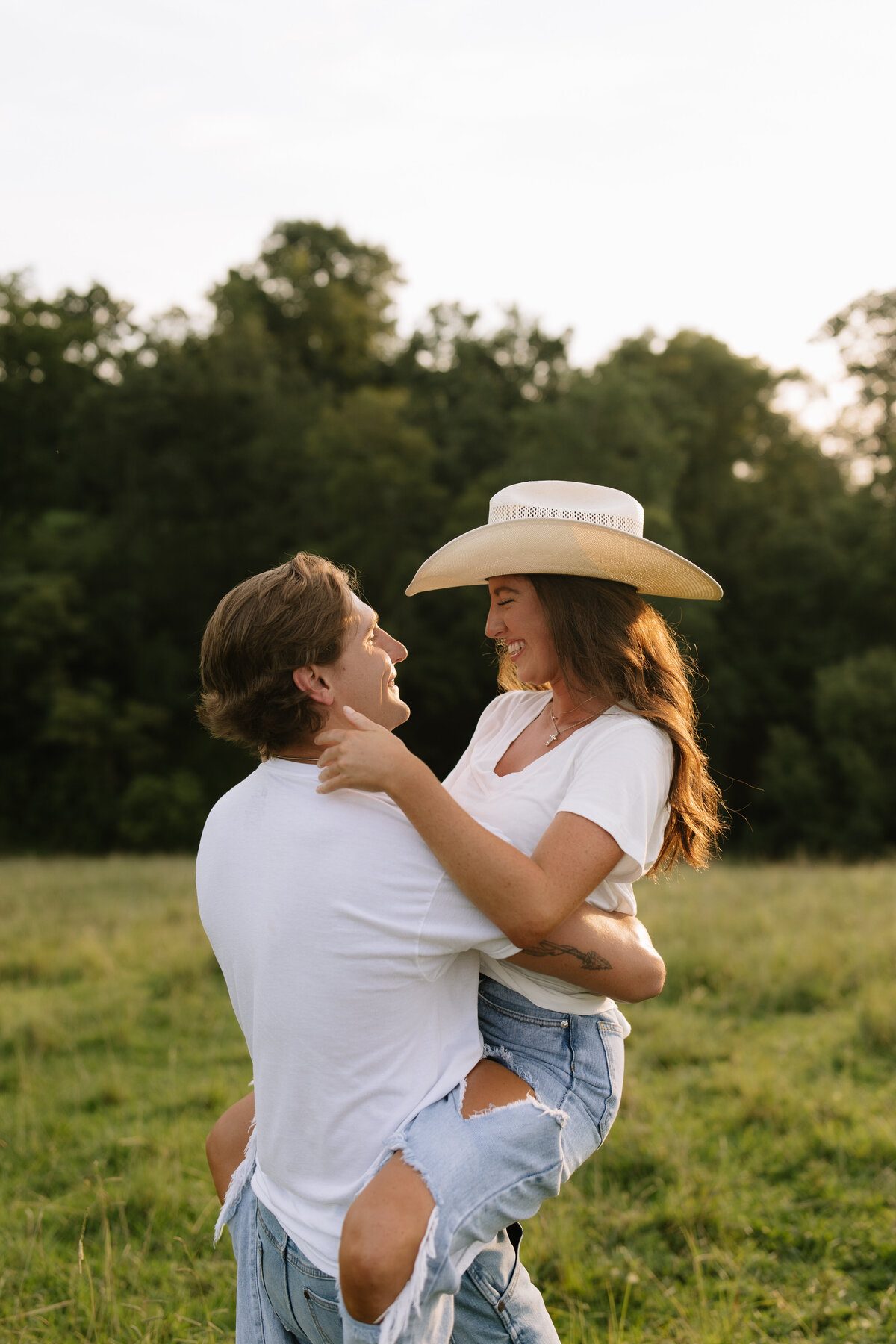 Authentic country couples session featuring cowboy hats in East Tennessee