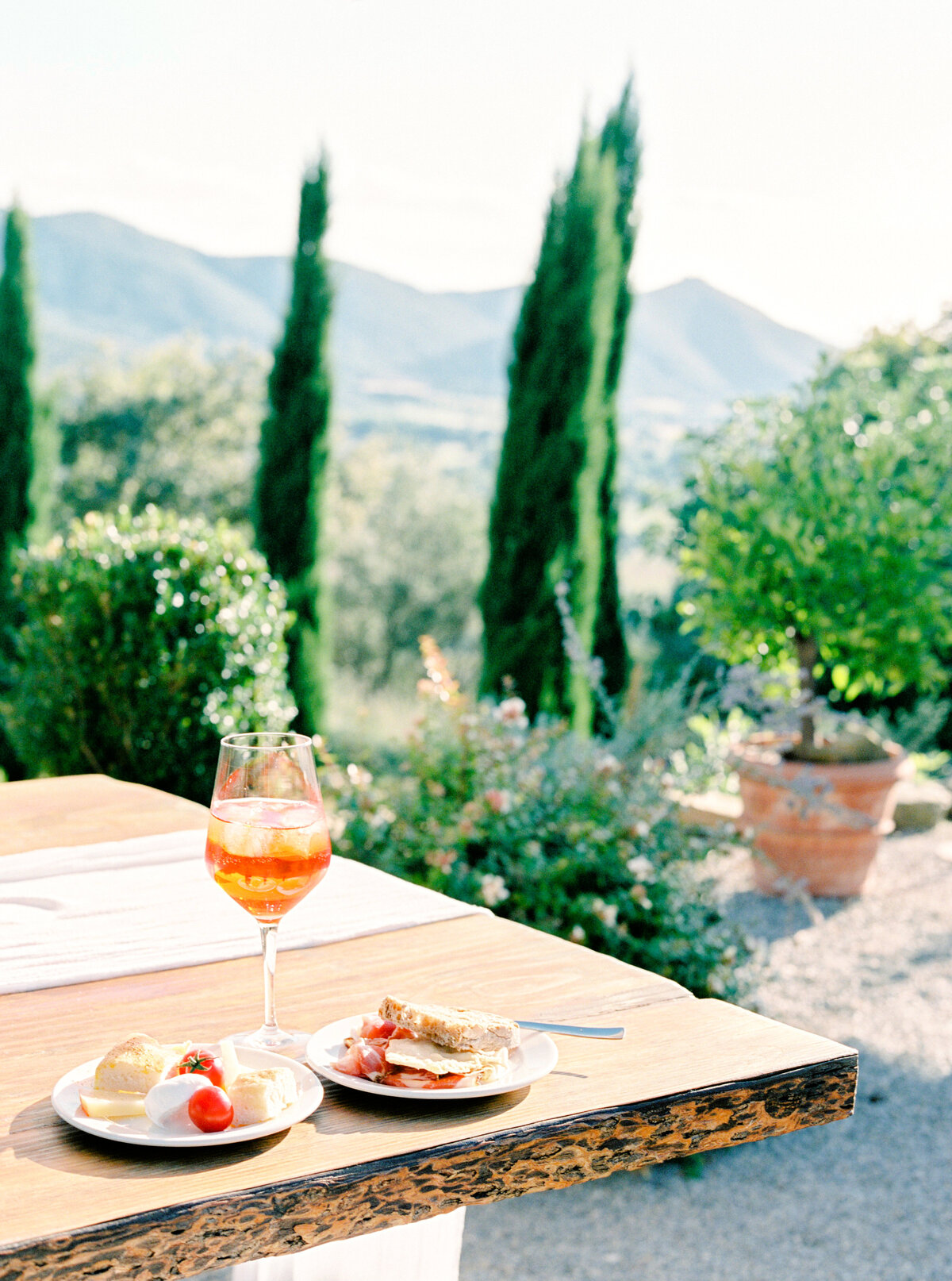 Film photograph of Aperol Spritz and charcuterie plates photographed by Italy wedding photographer at Villa Montanare Tuscany wedding