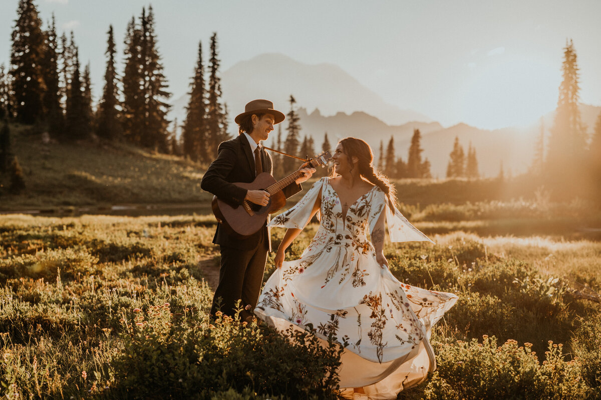 Couple dancing in an alpine meadow to celebrate their Washington State Elopement