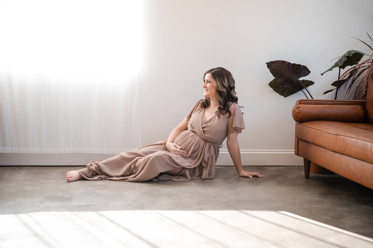 pregnant woman getting maternity photos taken in Plymouth Michigan studio