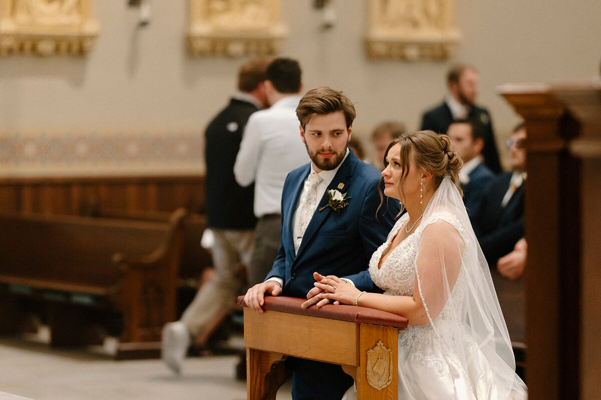 a bride and groom praying to Mary