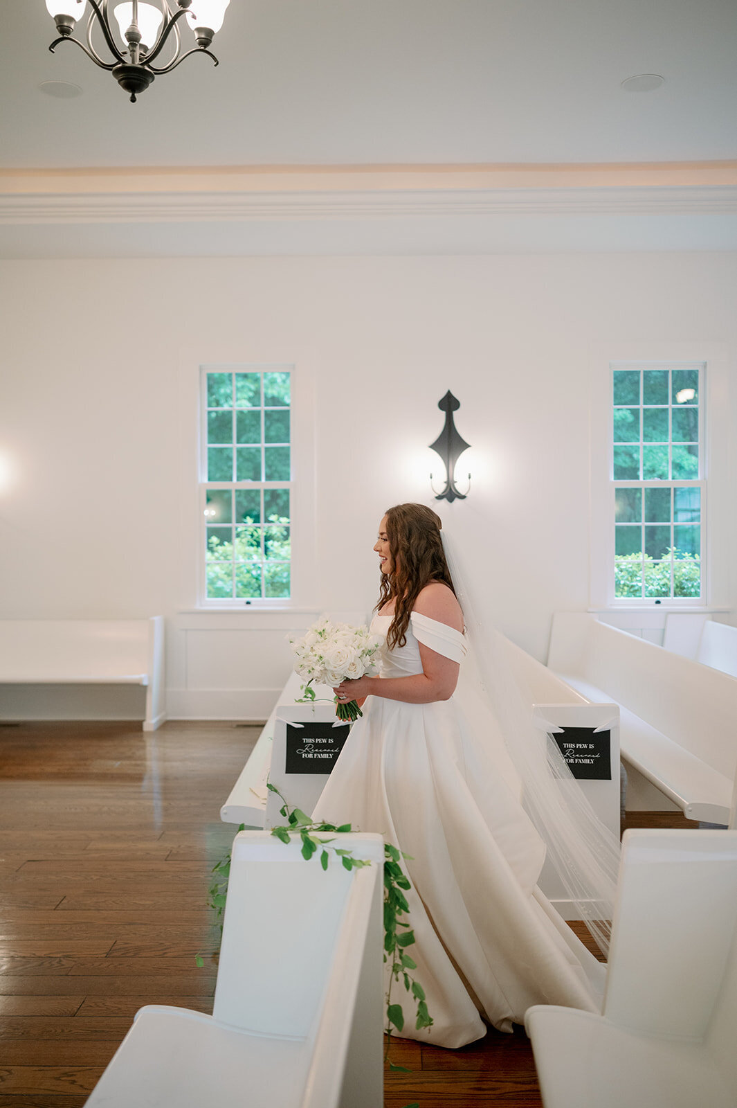 Bride holding her bouquet inside The Morris Estate chapel during quiet pre-ceremony moments.