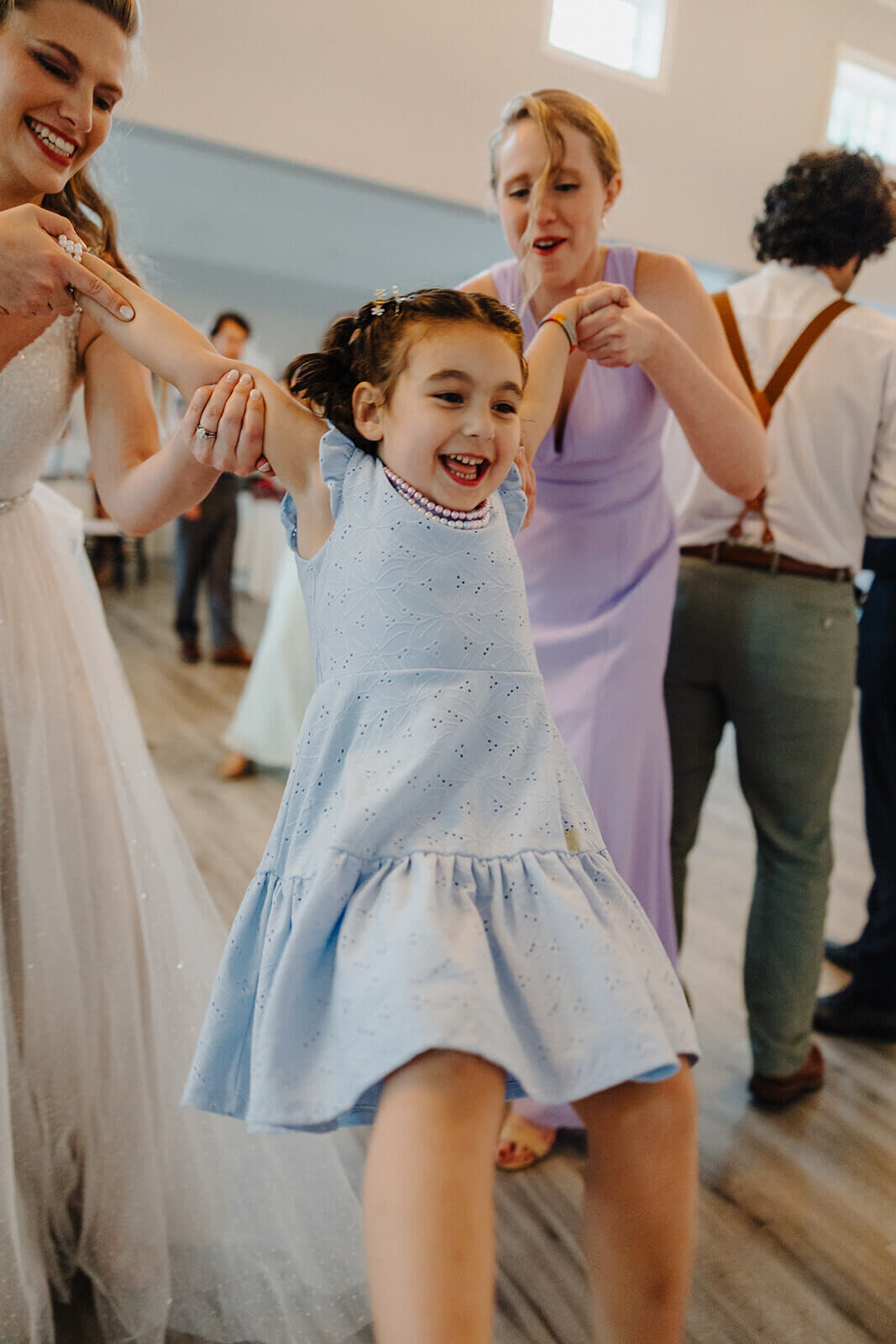 Little girl being swung in the air at Mansion at Keuka Lake, NY