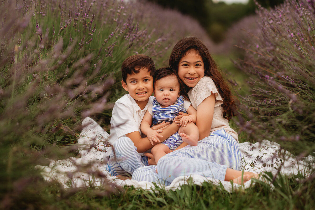 Siblings embrace during Family Photos in a Lavender Field in Asheville, NC.