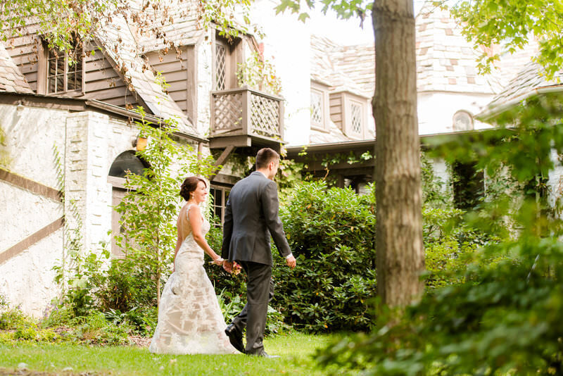 candid photo of a couple walking to their wedding reception at the Hyeholde restaurant in pittsburgh