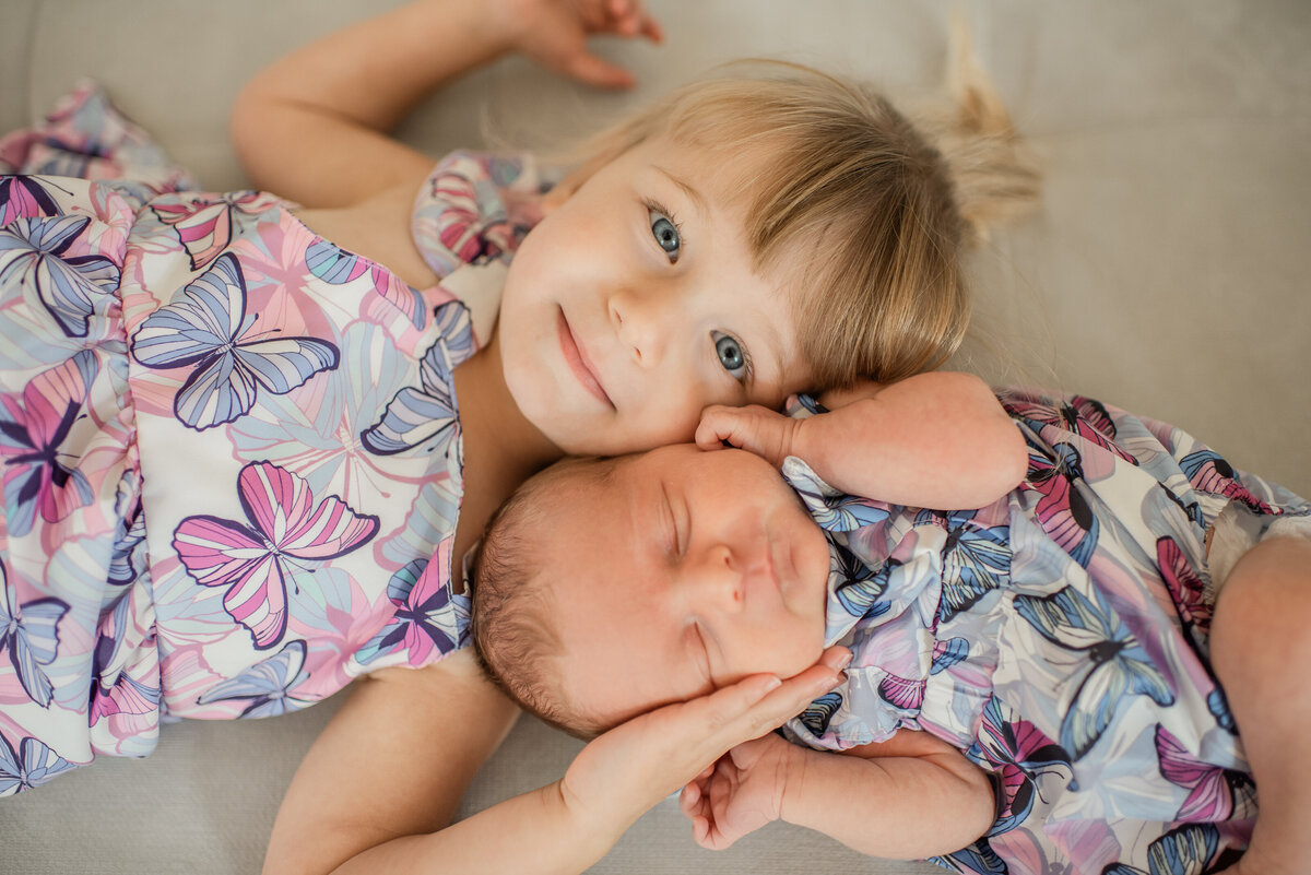 precious big sister holding newborn - maryland family photographer