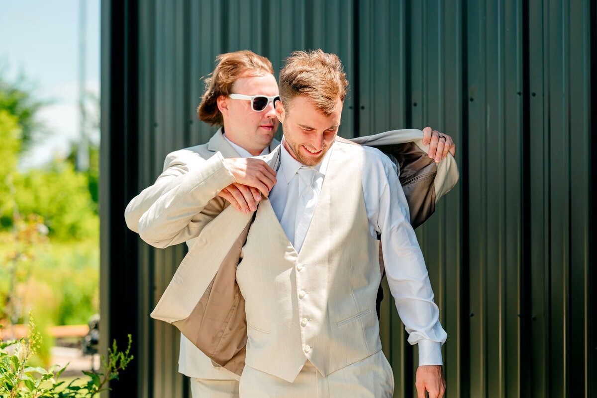groomsman-helps-jacket