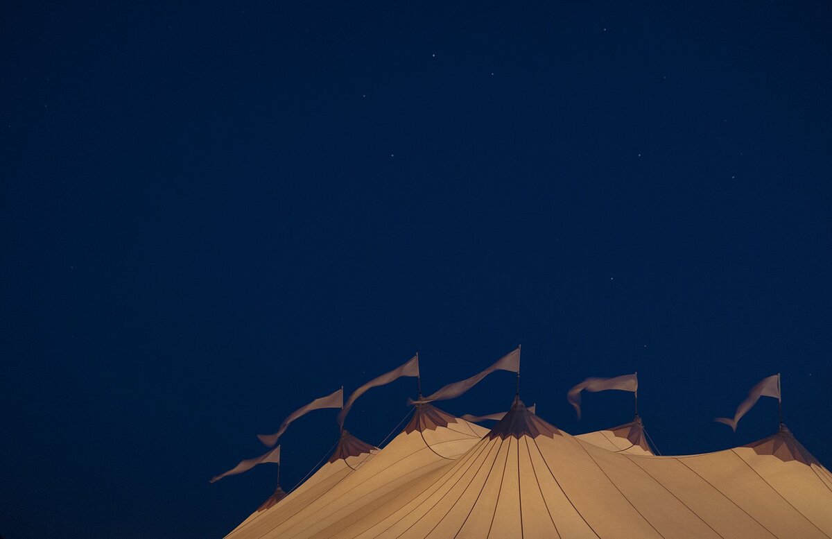 Sperry tent sails blow in the wind at twilight.