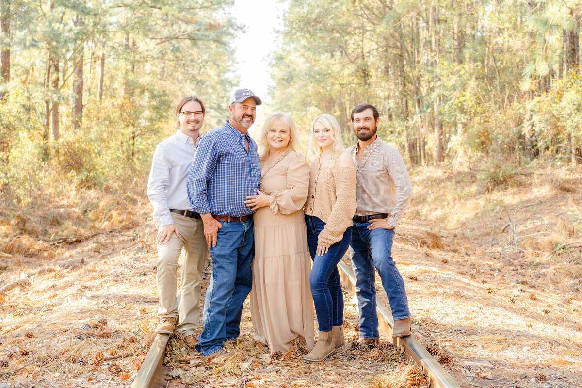 fall photo taken of mom and dad with their adult children at their family farm