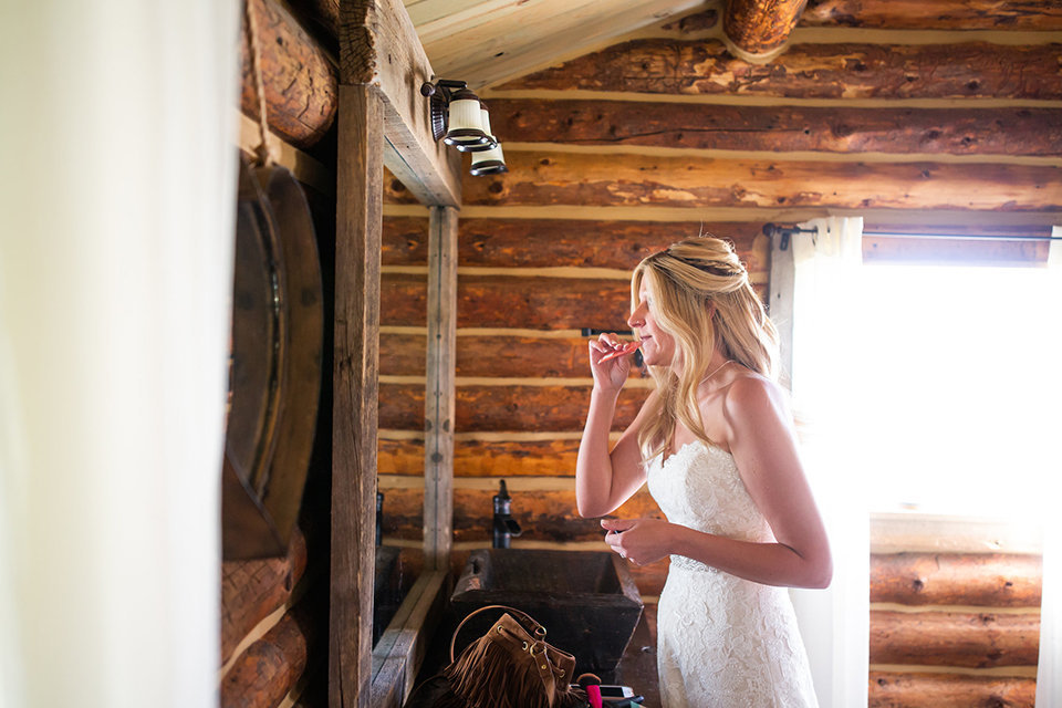Strawberry-Creek-Ranch-Wedding-Ashley-McKenzie-Photography-Small-Wildflower-Outdoor-Wedding-Bride-putting-on-makeup