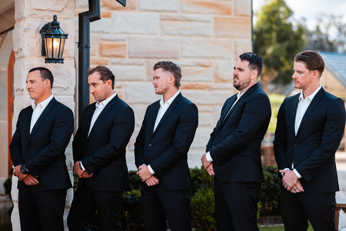 Handsome groomsmen lined up at the wedding ceremony