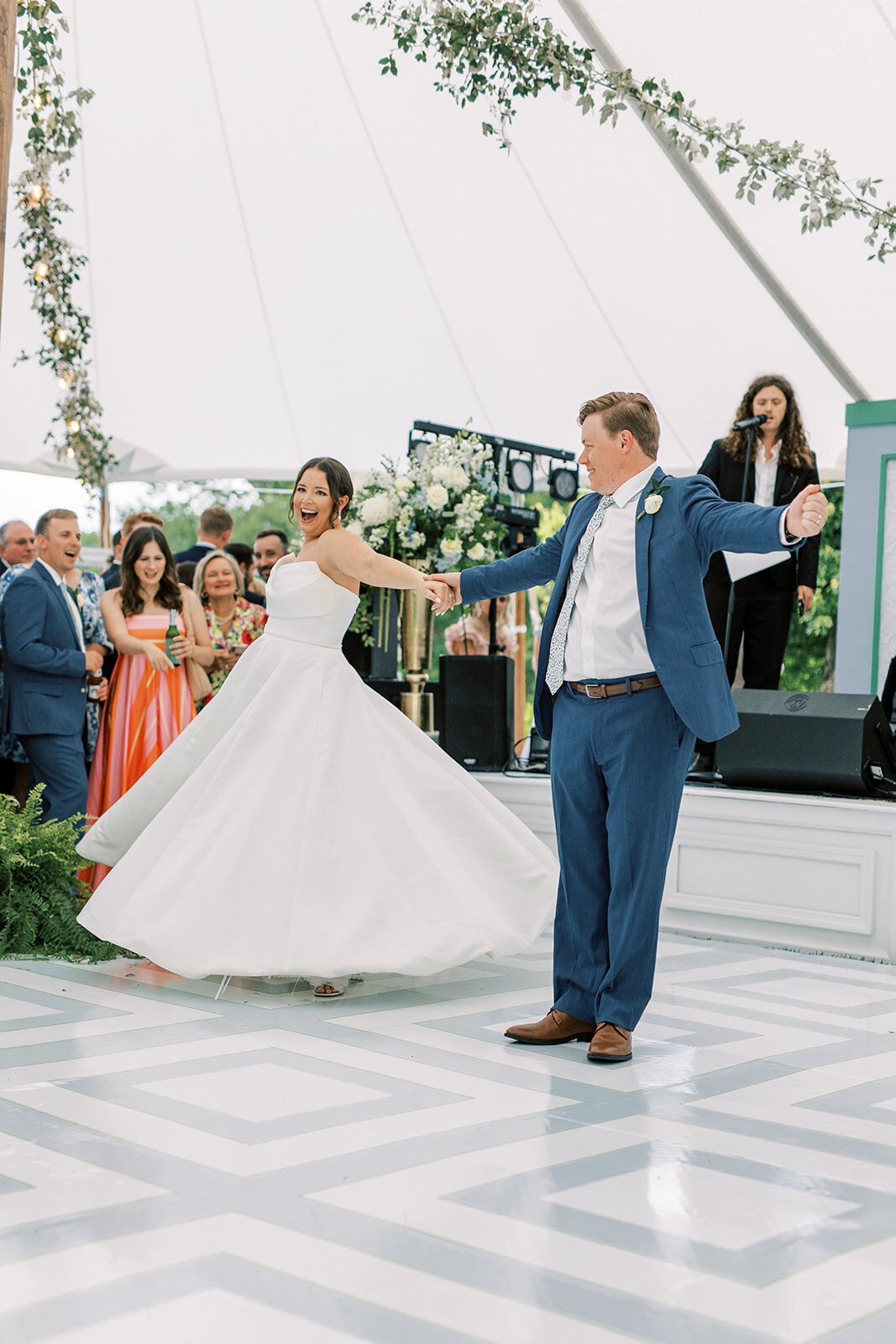 Couple dancing under a sailcloth tent with a live band during an outdoor wedding reception in Cashiers, NC.