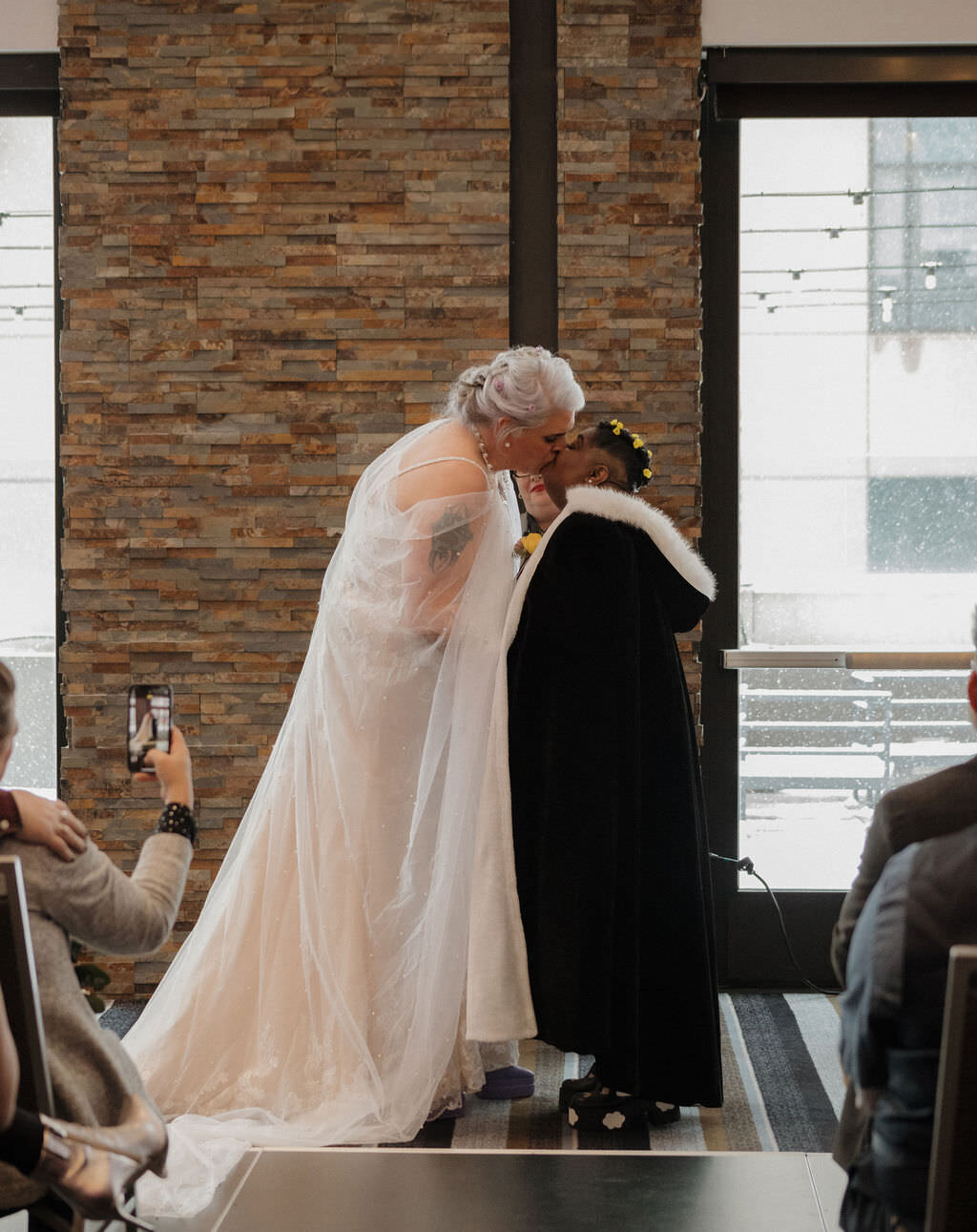 A couple's first kiss at their wedding.