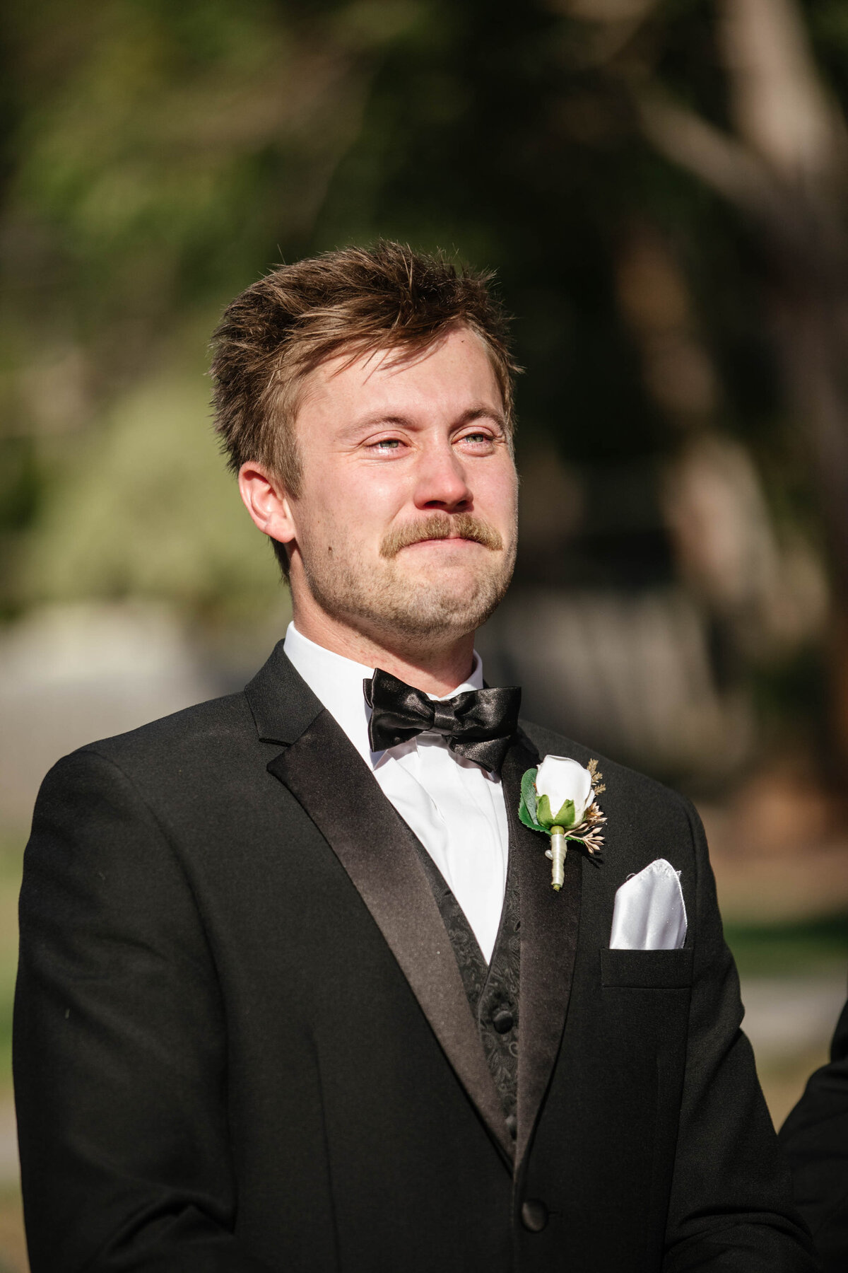  An Emotional groom weeps as he witnesses his bride walking down the aisle. 