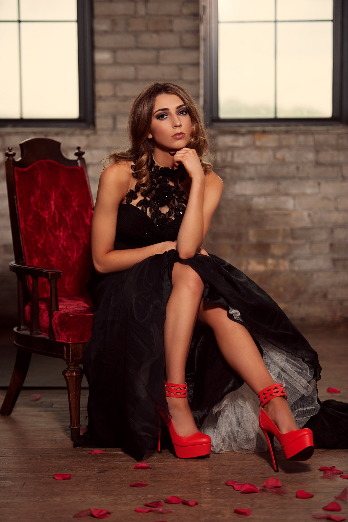 Girl in black dress and high heeled red shoes