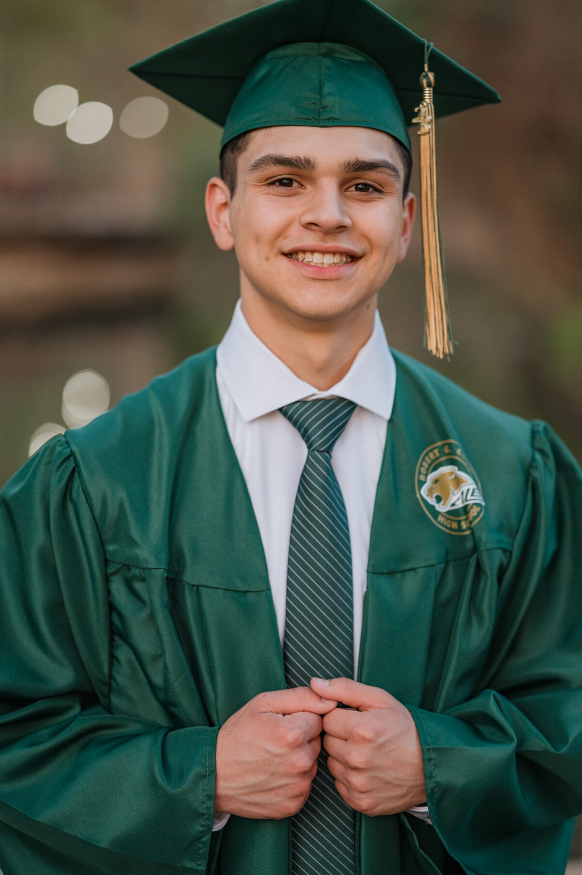 Senior portrait of a guy in his cap and gown by San Antonio senior photographer Cassey Golden.