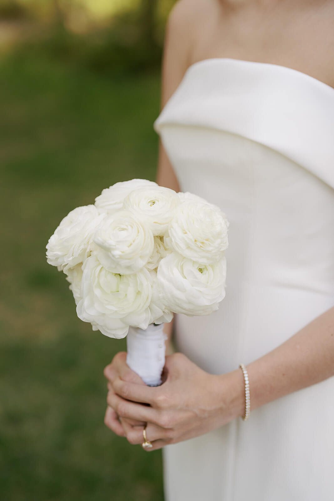 A close up of the simply elegant bridal bouquet of white roses at the Aspen Meadows Resort wedding.