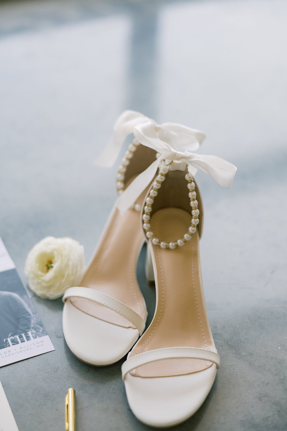 Pearl heels in a gray blue flat lay.