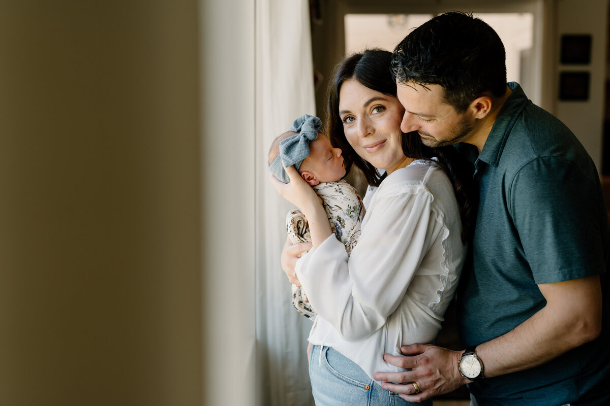 parents pose with newborn
