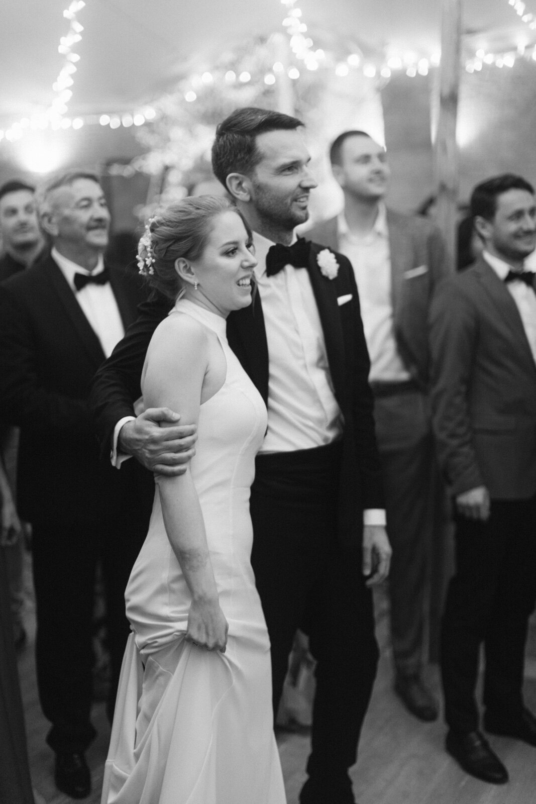 Bride and groom enjoying live music during wedding reception in Italy – candid emotional celebration.
