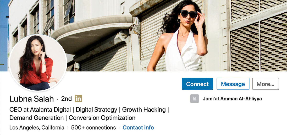 LinkedIn Profile Headshot with Banner Image of Lubna Salah circle insert red dress shirt arms and legs crossed one hand to her cheek background photo wearing white sleeveless blouse sunglasses standing against white building