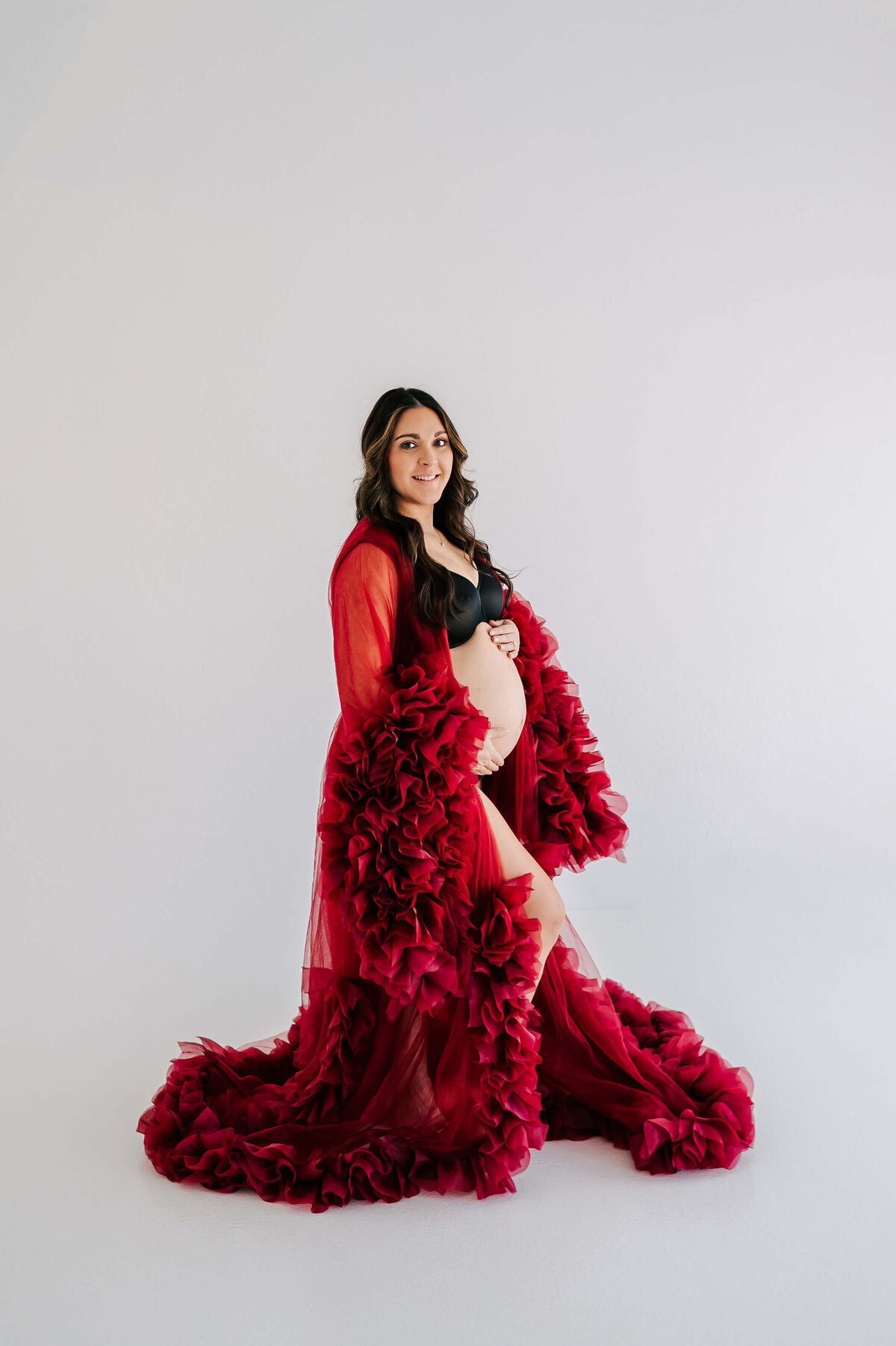 side profile of pregnant mom in red dress captured by Joplin MO maternity photographer Jessica Kennedy of The XO Photography