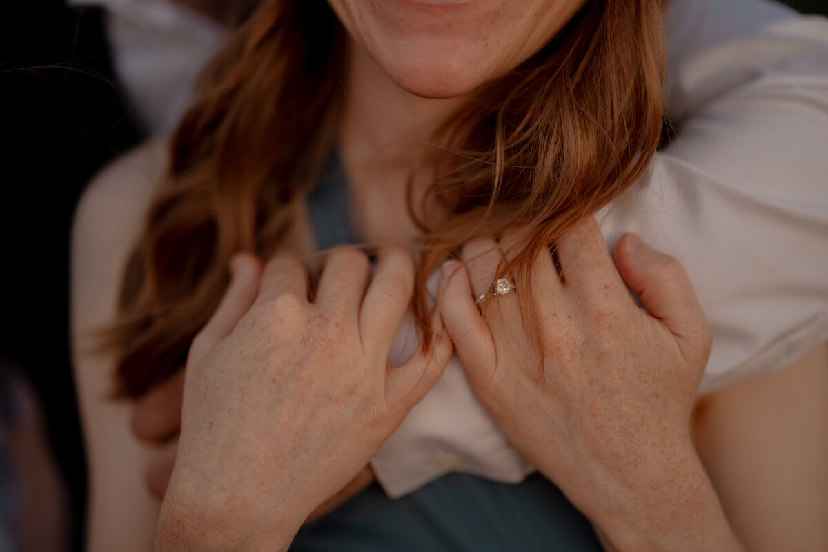 Couple standing against red rock backdrop during Sedona engagement session