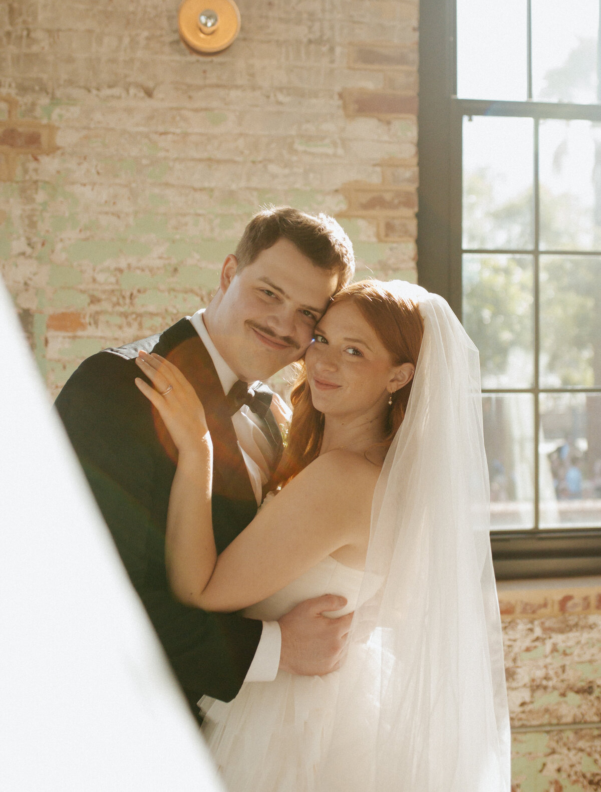 couple posing at charleston wedding venue, the cedar room