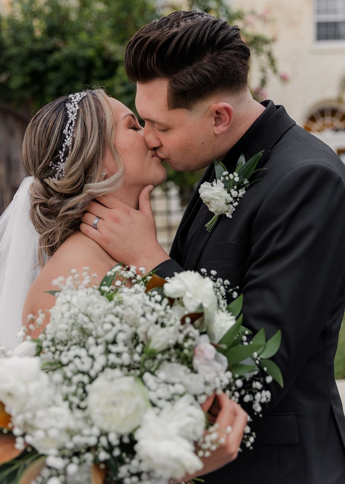 Groom kissing bride at Bella Cosa, Lake Wales, Florida