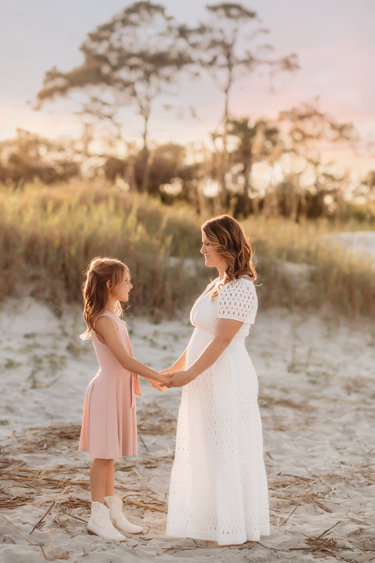 Mother holds hands with her daughter during Family Photoshoot on Folly Beach.