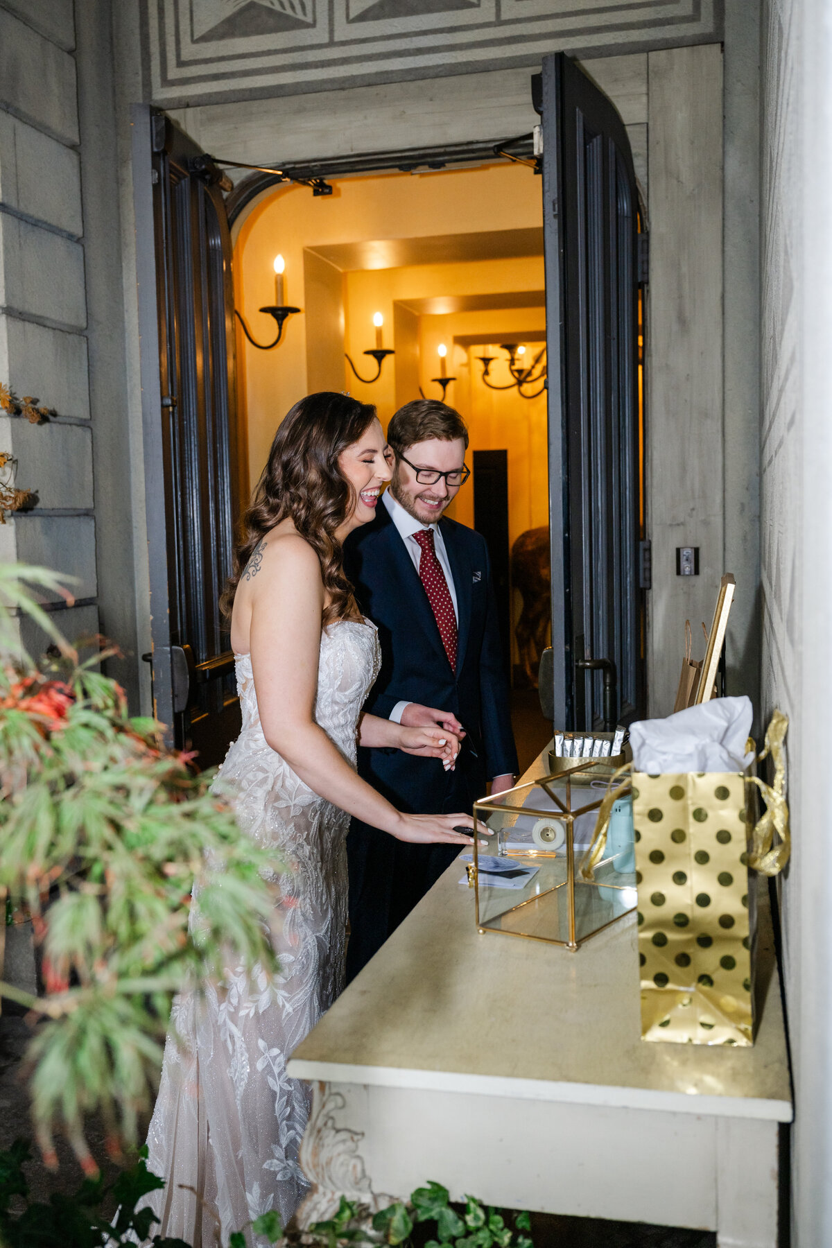 bride and groom look at wedding guest book