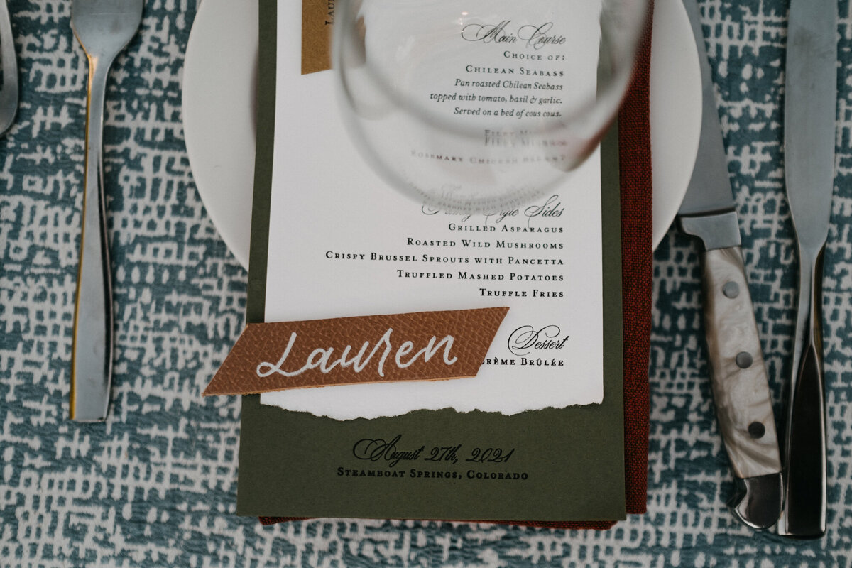 Calligraphy place card of bride's name, on top of menu