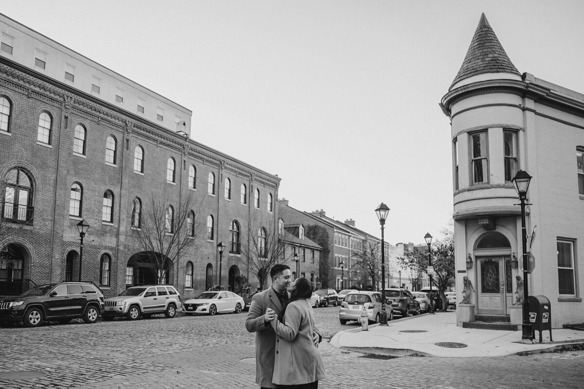 A couple dancing on the street in a city 