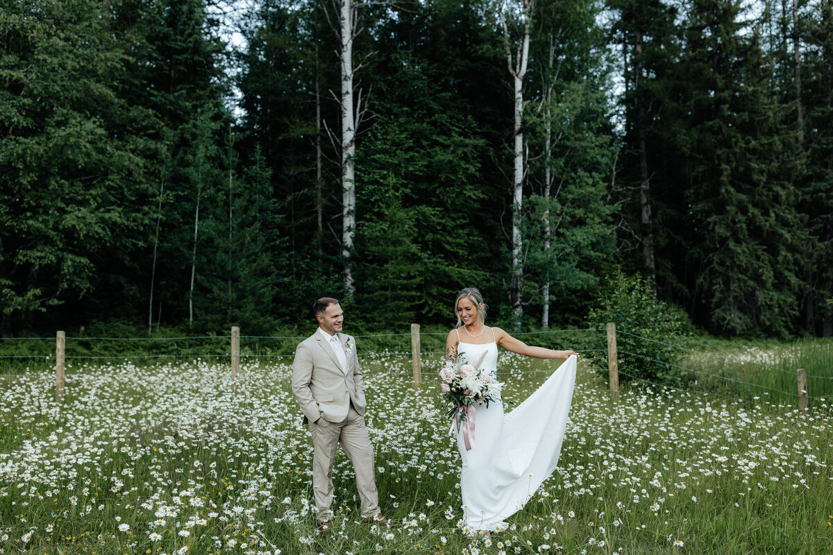 Wedding & Elopement Photogrpahy, bride and groom walking in a large grassy field