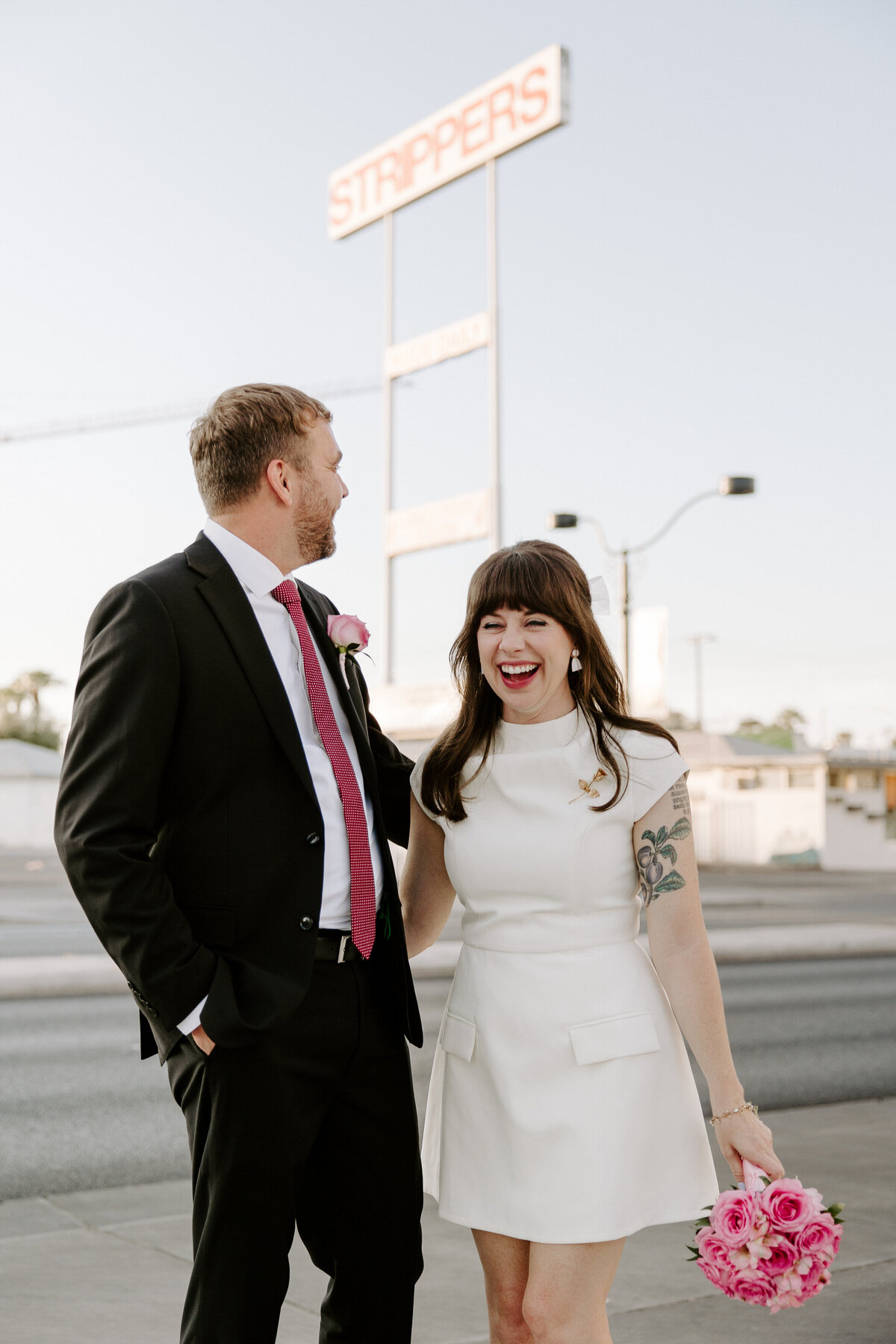 A couple smiles outside on their elopement day.