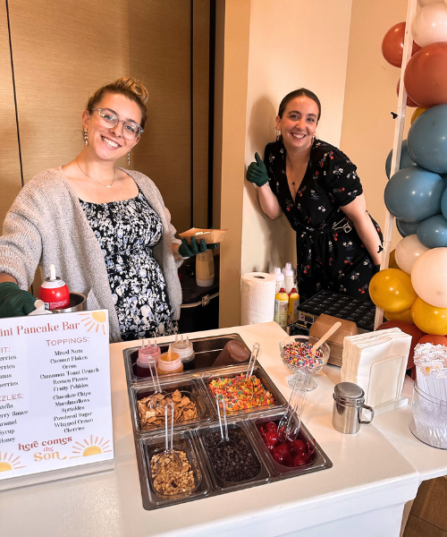 Pancake bar setup with toppings and signage