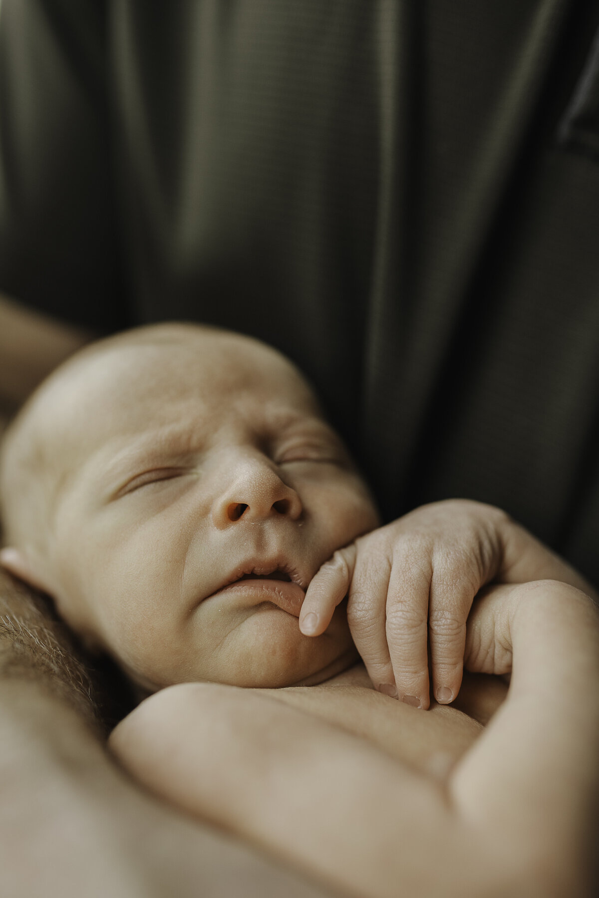 Verona B Photography captures baby details of a newborn – an up-close picture of smushy newborn lips, nose, and fingers at an in-home newborn session near Akron, Ohio. Up close pictures capture the details that would otherwise fade in your memory.