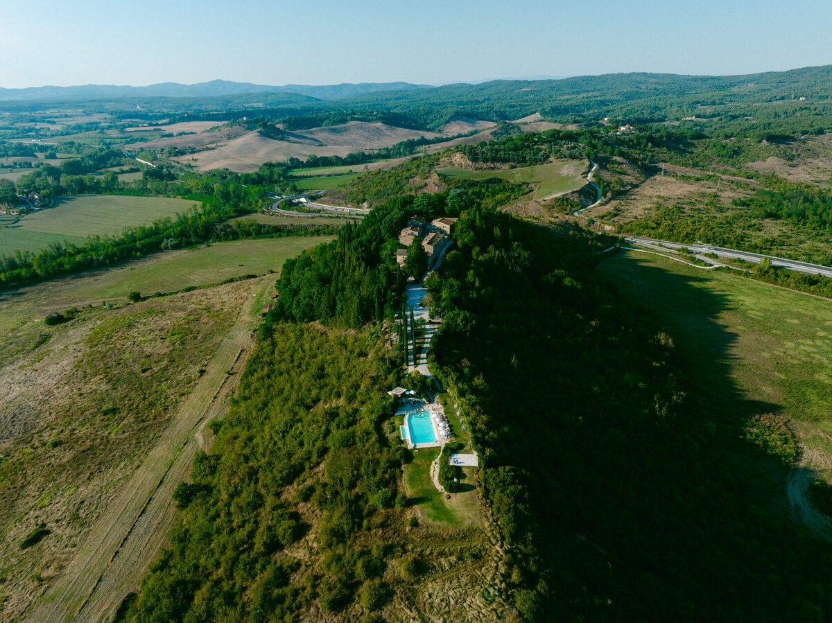 An aerial wedding drone photo of a welcome dinner at Laticastelli in Tuscany Italy.