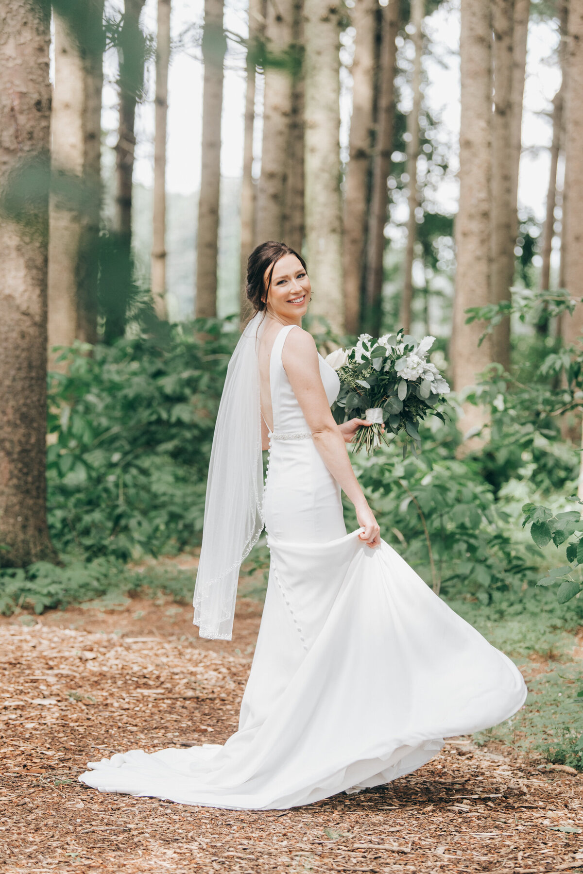 An elegant bride twirling and dancing in her white wedding dress