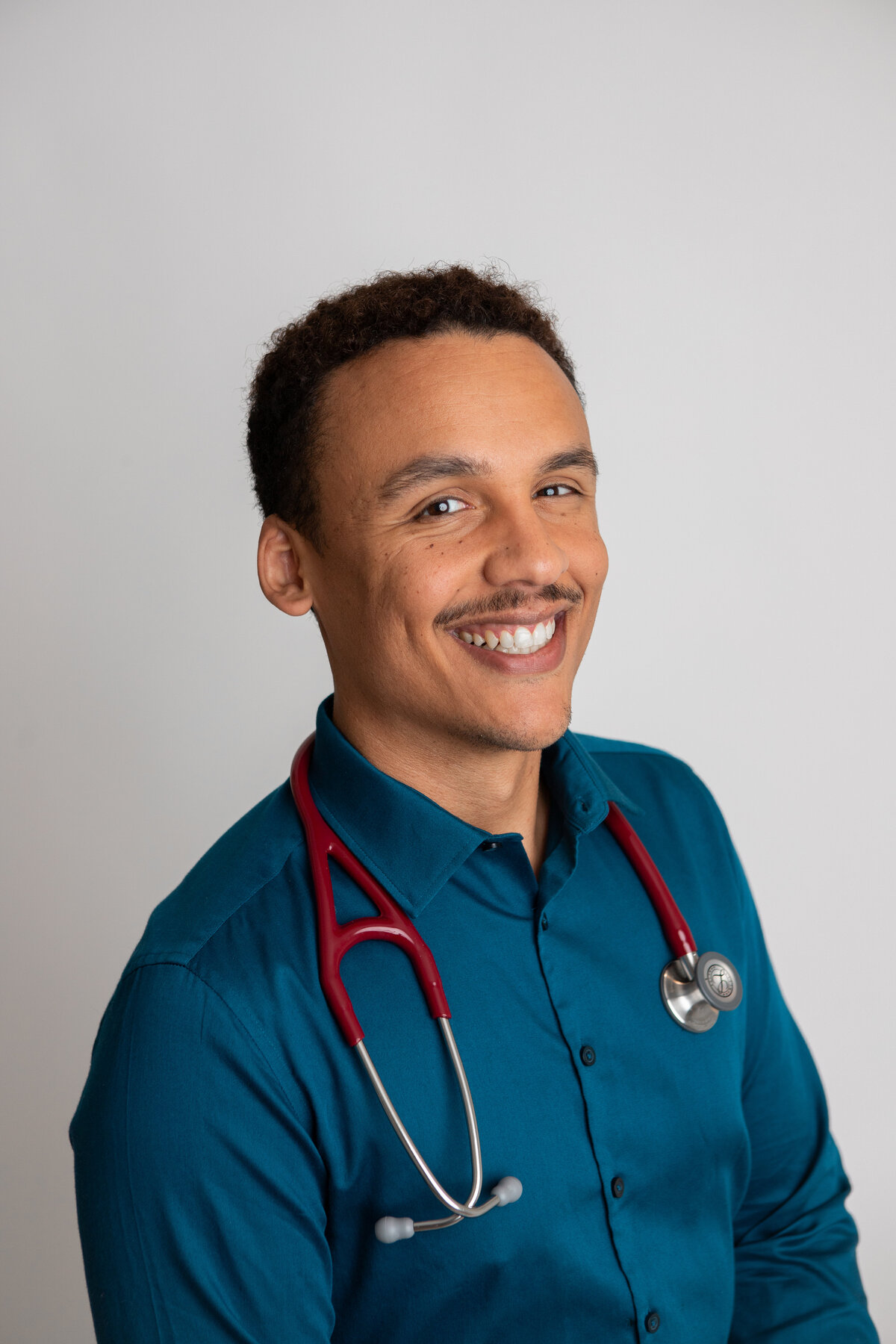 Teal shirt and red stethescope headshot