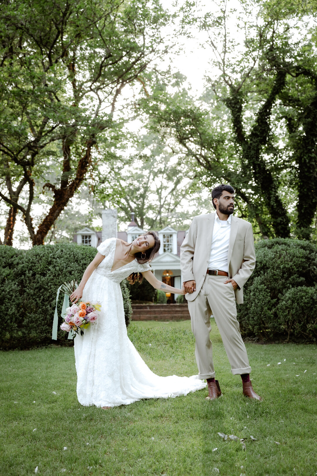 Bride and groom smiling together in a lush green garden during their spring elopement in Atlanta.