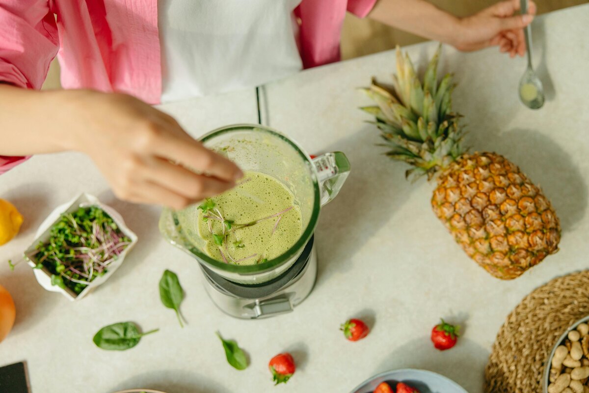 Top overlay of woman making a smoothie with fruits